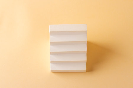Composition with a concrete staircase in the style of minimalism on a delicate background.