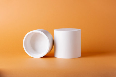 Composition with concrete cylinders in the style of minimalism on delicate background.の写真素材