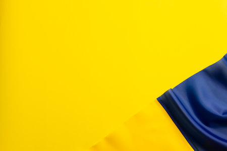 Textured flag of Ukraine on a yellow background in honor of Independence Day.の写真素材