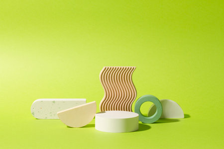 Composition of plaster decorations of different geometries on a lime green background.