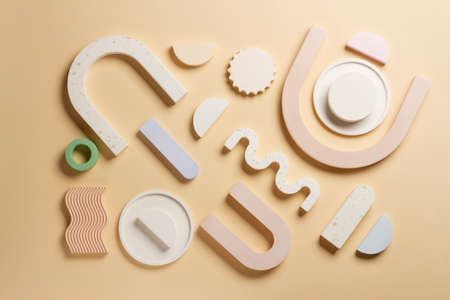 Composition of plaster decorations of different geometries on a delicate background.