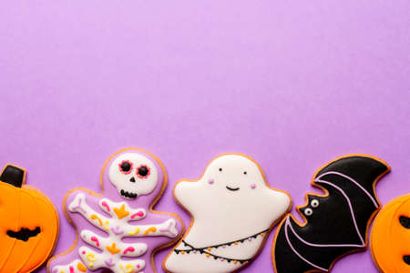 Homemade Halloween cookies, pumpkins, ghosts, bats on purple background.の写真素材