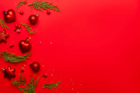 Christmas composition with decorations and ornametns on red background.