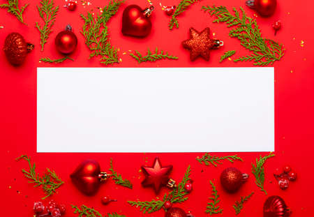 Christmas composition with ornaments on red background with space for text.の写真素材