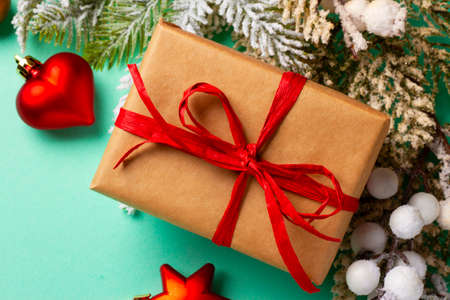 Christmas composition with decorations and ornaments on a mint background.