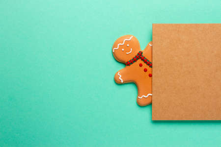 Christmas composition with decorations and cookies on a mint background with space for text.