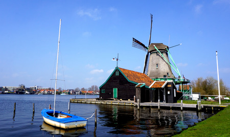 Windmills and river and boat in hollandのeditorial素材
