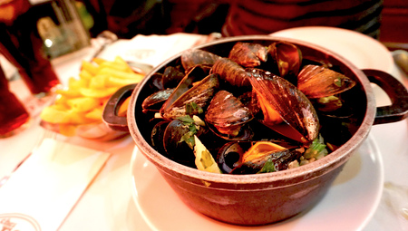 baked mussels with white wine with frenchfried in belgiumの写真素材