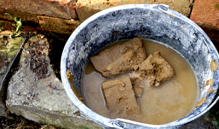 clay brick in water bucketの写真素材