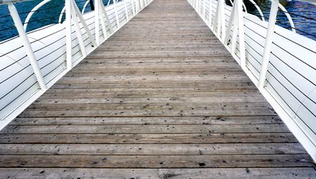 Wooden floor bridge and white railing over Danube riverの写真素材