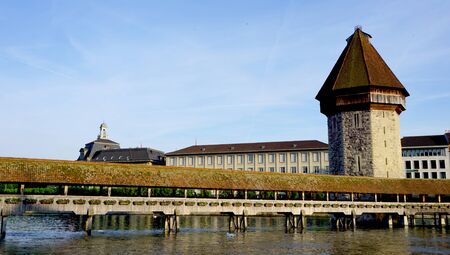 historical wooden Chapel Bridge and tower in Lucerne Switzerlandの写真素材