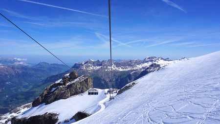 scenery of snow mountains titlis and cable car Engelberg Switzerlandの写真素材