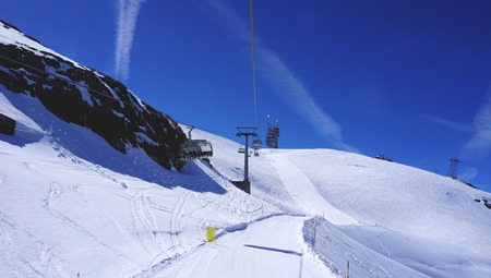 suspended ski cable car track at snow mountains Titlis Engelberg Switzerlandの写真素材