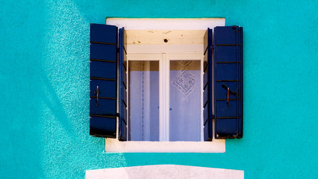 blue Window in Burano on blue ccolor wall building architecture, Venice, Italyの写真素材