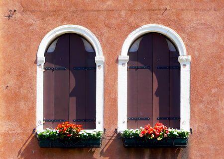 two arch window and ancient decay orange wall building architecture in Murano, Venice, Italyの写真素材