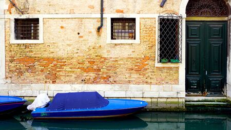 canal and boats with ancient buildings background in Venice, Italyの写真素材