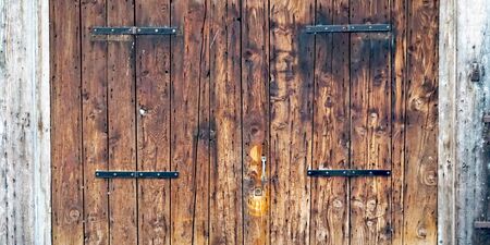 close up charming old wooden door house building in Venice, Italyの写真素材