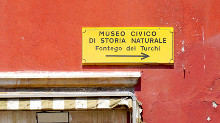 red color wall with sign in Venice, Italyの写真素材