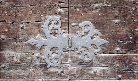 door hinge fitting flap art of old wooden door in Venice, Italyの写真素材