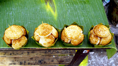 Sweet and Savory Grilled Coconut-Rice Hotcakes, Coconut Rice Cake on banana packaging, Asian...