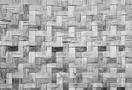 Wall of plaited bamboo strips vernecular outdoor texture material grey scale