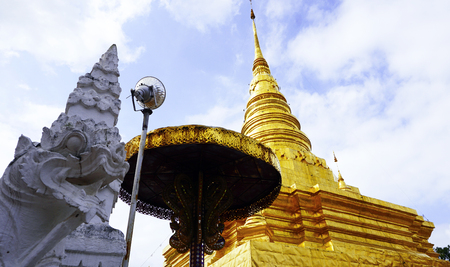 white serpent and golden Pagoda in Temple, nan, Thailand (Wat Chae Haeng)の写真素材