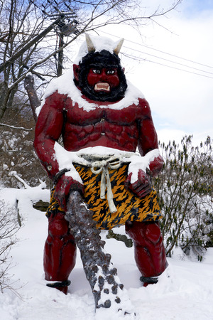 Red giant myth sculpture at Noboribetsu onsen snow winter national park in Jigokudani, Hokkaido, Japanの写真素材