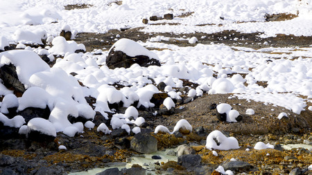 Closeup stone and snow in the mist Noboribetsu onsen snow winter national park in Jigokudani, Hokkaido, Japanの写真素材