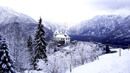 Scenery of Hallstatt Winter snow mountain landscape hike epic mountains outdoor adventure and lake through the forest in upland valley leads to the old salt mine of Hallstatt, Austriaの写真素材