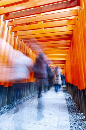 People walking through the pathway of Torii Gates (Japanese wooden gate) at Fushimi Inari Shrine (Japanese Temple) in Kyoto.のeditorial素材