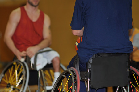 Men in wheelchair playing basketballの写真素材