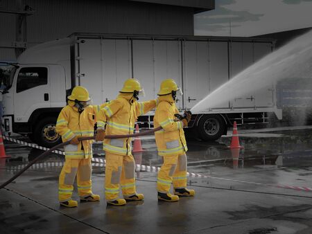 The fire fighting team were handle the emergency situation by spray the waterの写真素材