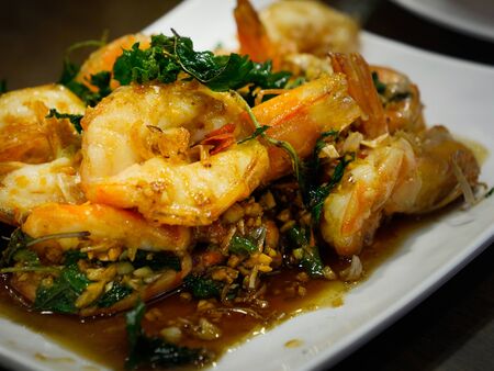 closeup picture of fried shrimp with chilli and Thai herb for serve on the dishの写真素材