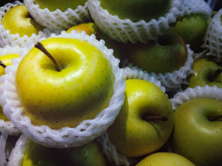 The gsroup of green apple were put in the basket for sell in the suppermarketの写真素材