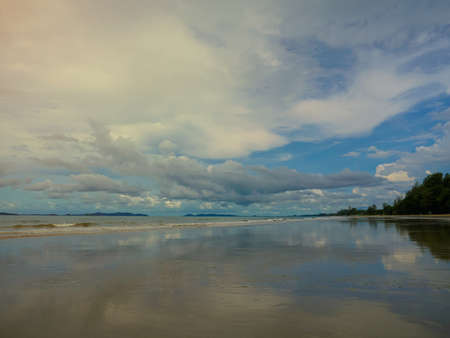Quiet beach with blue sky and wide sand beachの写真素材