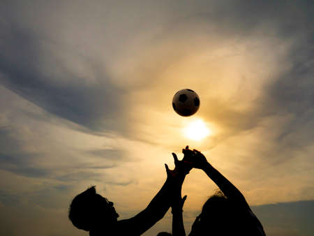 Ball challenge game to catch the ball with yellow light and sun backgroundの写真素材