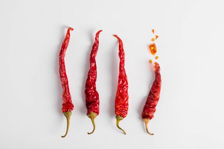 Dried red chili peppers on a white background. Dry vegetables. Spice