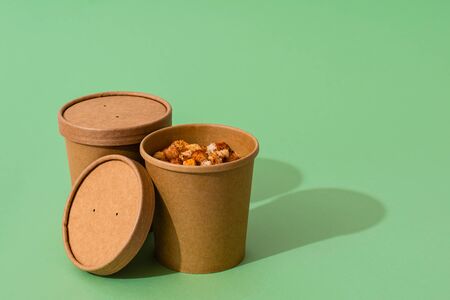 Potato cream soup with croutons in craft containers on  greenの写真素材