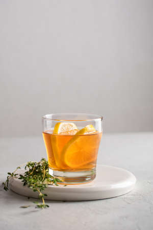 Autumn and winter traditional drinks. Warming hot tea with lemon and thyme