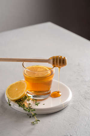 Autumn and winter traditional drinks. Warming hot tea with lemon, honey and thyme. Healthy drinkの写真素材