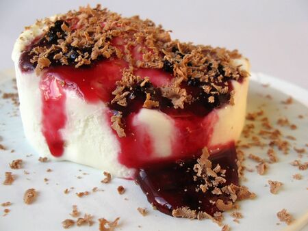Vanilla ice cream with currant syrup and grated chocolate の写真素材