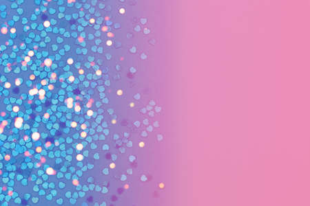 Background with hearts in blue, pink and purple gradient covered with bokeh
