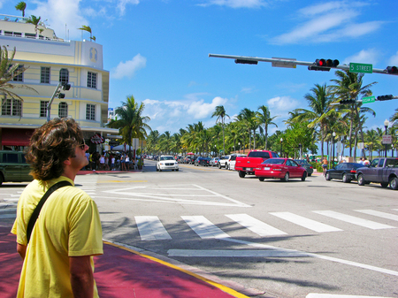 Miami, Florida, USA - May 28, 2007: At the intersection of the Fifth Avenue and Ocean Drive, a man standing on the corner, waiting for the traffic light green signal to cross.のeditorial素材