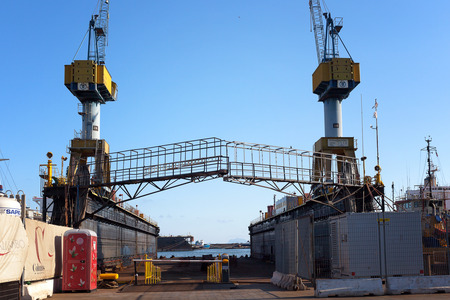Naples, Italy - August 10, 2016: In the industrial port a special scaffolding in steel with two cranes next door, used on site to work on the hulls of boats.のeditorial素材