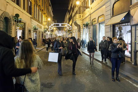 Rome, Italy - November 16, 2016: Crowd in Via dei Condotti for Christmas shopping, near the Spanish Steps. The road of the big names in fashion is decorated with lights and Christmas decorations.のeditorial素材