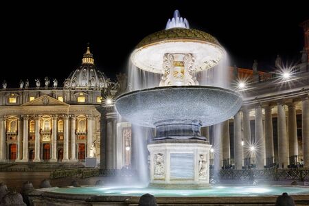 Rome, Italy - January 1, 2017: The so-called ancient fountain is one of two twin fountains Placed in St. Peter's Square at the Vatican. Here at night shooting in a long exposure, the background, the facade of the temple basilica in Christendom.のeditorial素材