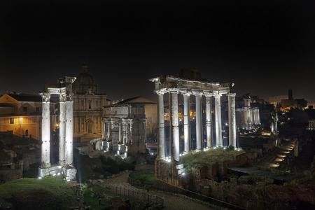 The Roman Forum photographed at night with artificial lights.The Roman Forum: in the foreground the Temple of Saturn, to the left of the Arch of Septimius Severus.の写真素材