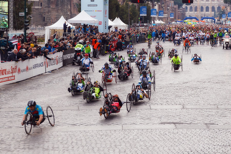Rome, Italy - April 2, 2017: hand cycle, the departure of the athletes on Via dei Fori Imperiali, the Coliseum on background.のeditorial素材