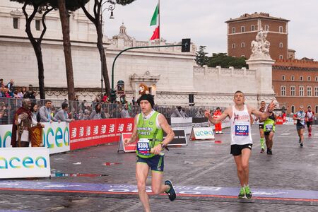 Rome, Italy - April 2nd, 2017: Athletes participating in the 23rd marathon in Rome arrive exhausted at the finish line on Via dei Fori Imperiali.のeditorial素材