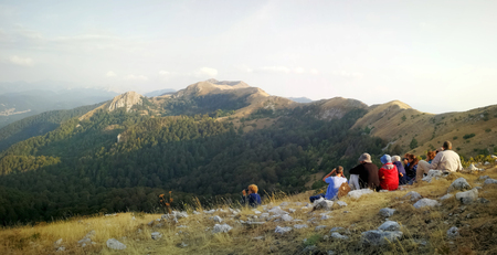 Pescasseroli (AQ), Italy - August 31, 2017: A group of hikers in the mountains near the village, seated on a summit to admire the landscape and wildlife.のeditorial素材